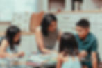 Image of family on floor learning