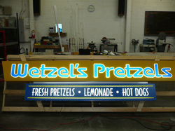 Single-sided illuminated cabinet with push-thrus