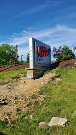 Double-sided layered cabinet with halo-lit logos