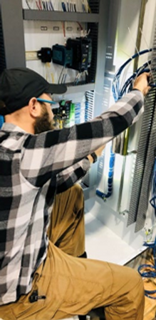 HSQ technician repairs a control panel for field communications for water system