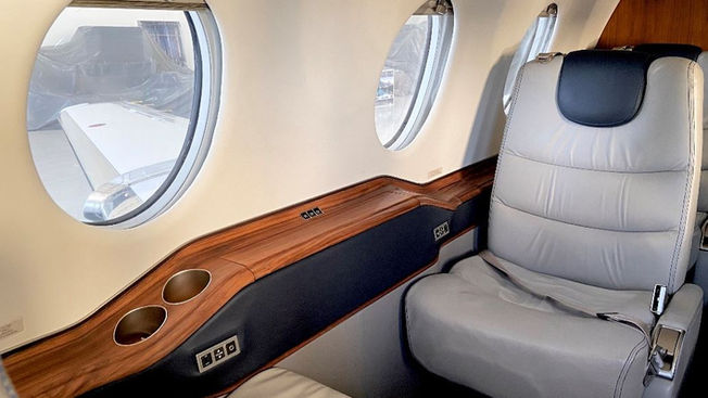 Spacious and elegantly designed interior of a Beach Jet private aircraft, featuring comfortable seating and modern amenities for a luxurious travel experience