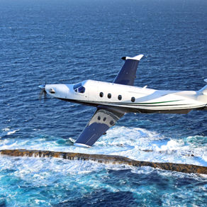 Pilatus PC-12 over the ocean on a private chartered flight