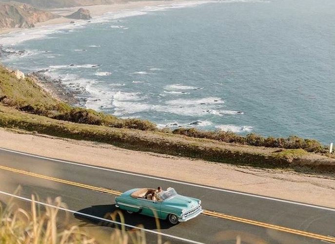 Luxury convertible cruising Big Sur coastline on Highway 1 as part of an MPI Jet coastal journey