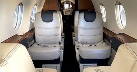 Luxurious and comfortable interior of a Beach Jet private aircraft, featuring plush seating and modern amenities for an exceptional travel experience.