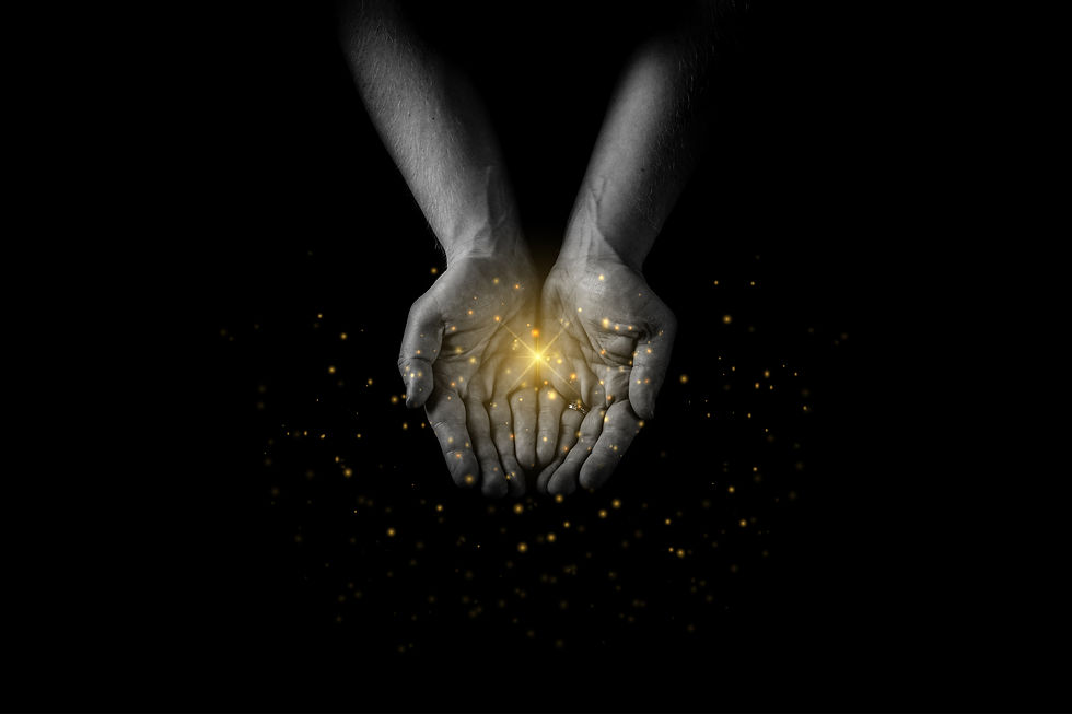 Hands cupped together holding a glowing golden light against a black background. Sparkles surround the hands, creating a magical feel.