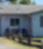 Front of men's house of Yamhill Hope Center a one story blue building with blue front door. Where men can go to receive reentry services.