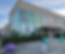 Front of Bybee Lakes Hope Center, a three story concrete building with large glass windows that have designs on them. Sign on building says Bybee Lakes Hope Center at the Jordan Schnitzer Campus. Where people can go to receive homeless services in Multnomah County.