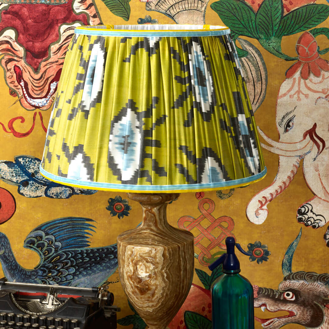Maximalist interior design, handmade golden green silk ikat lampshade in patterned wallpapered sitting room