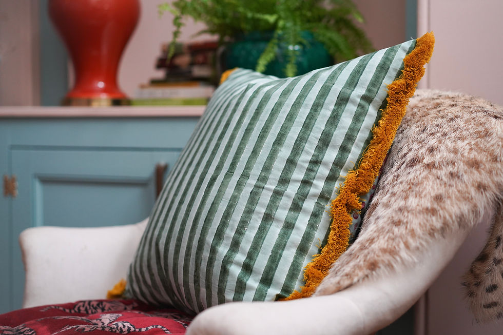 Thumbnail: Bright striped vintage blockprinted cushion with red ruby horses and yellow fringing on white sofa