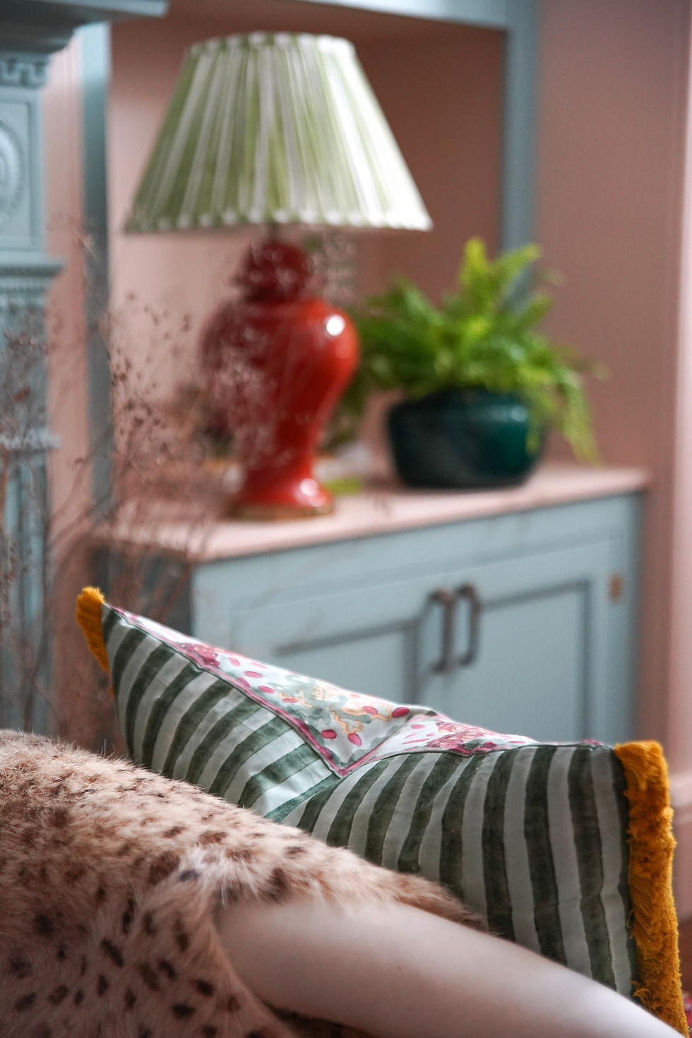 Thumbnail: Bright vintage blockprinted cushion with red ruby horses and yellow fringing on white sofa
