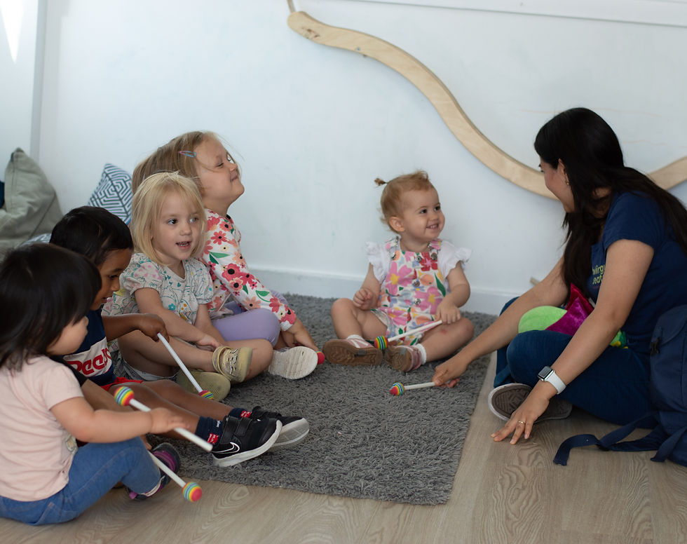 A Bilingual Beats music teacher and children in a nursery session.