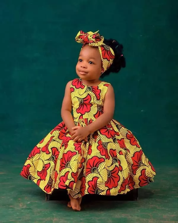 Little girl wearing Ankara princess dress with headwrap