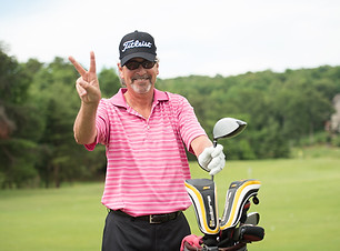 Photo of a happy man at a golf course.