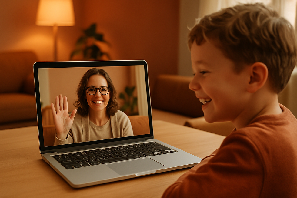 Young child grinning at a laptop screen showing a friendly therapist waving back during what is spasmodic dysphonia