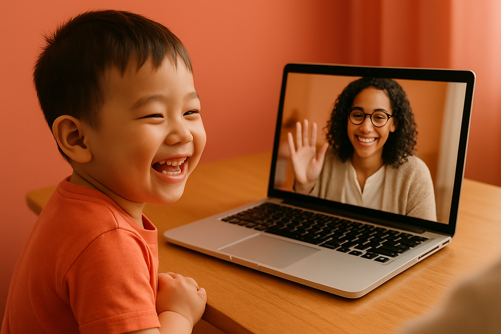 Young child grinning at a laptop screen showing a friendly therapist waving back during speech milestones concern points