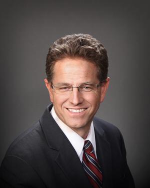 Smiling man in suit and glasses