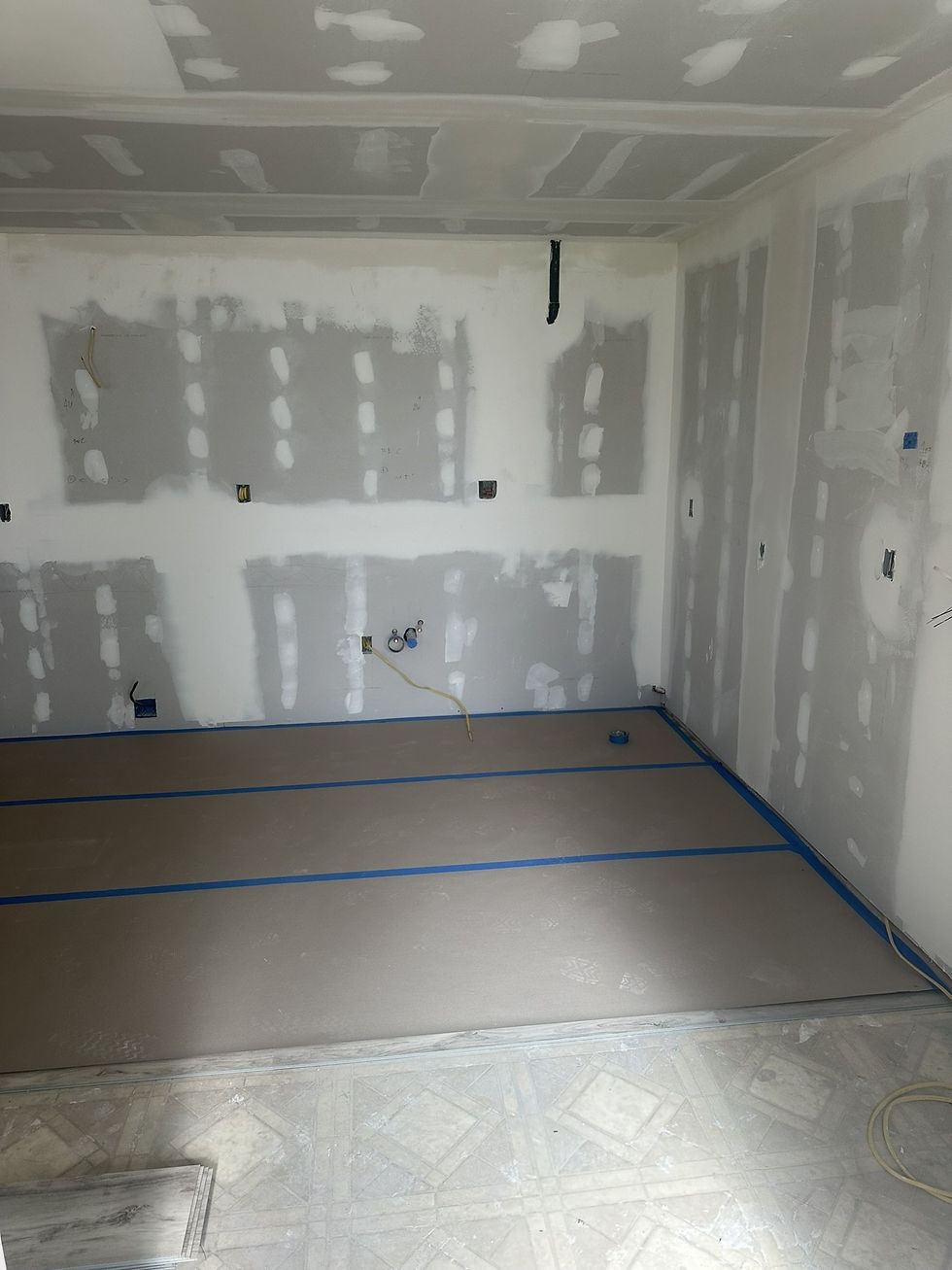 Room with taped drywall seams on ceiling and walls