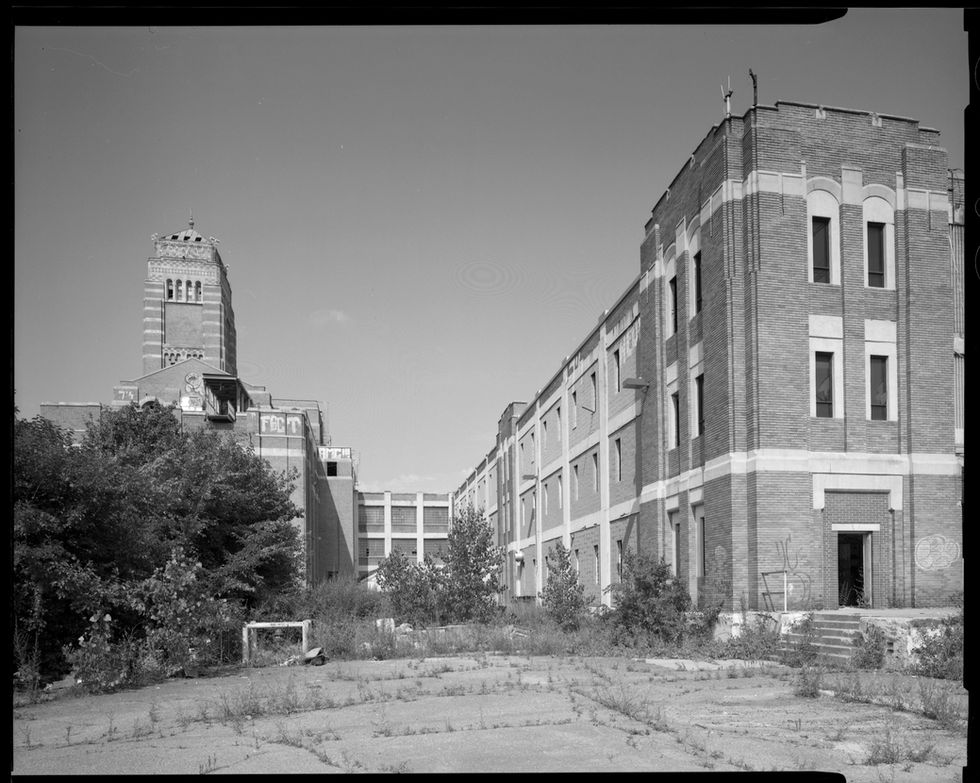 Looking west, factory on right, administration building on left
