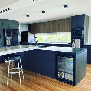 Residential new home build. Black island bench, drinks fridge, Stone bench top. Buddina, Sunshine Coast. Tim Unsted Building