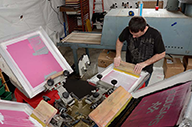 Josh Love of N The Zone printing on his manual press