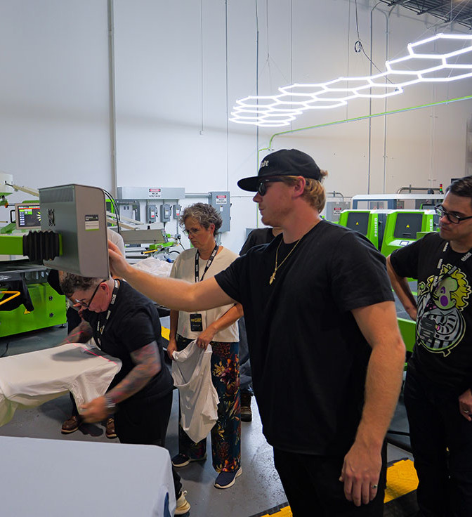Contract Technician Zach Achorn operating a ROQ Automatic Screen Printing Press at the ROQ US Tech Center
