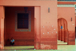 Man sitting on an invisible chair.