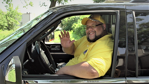 Happy My-tti Luxury SUV chauffeur providing executive limo transport service to a client.