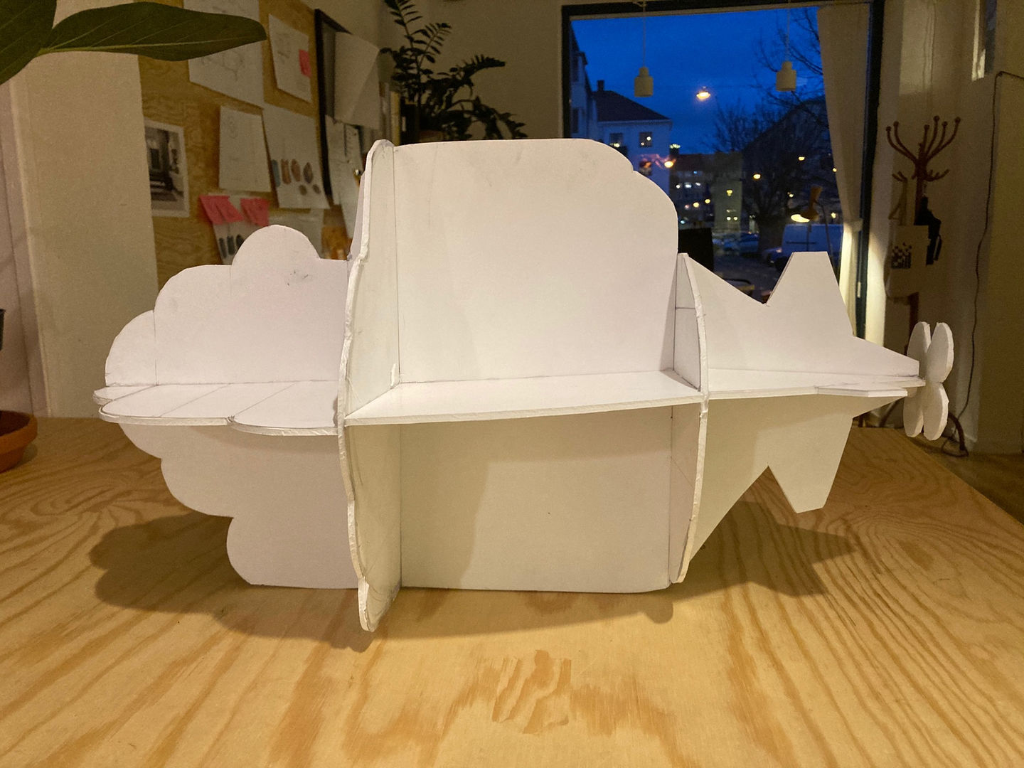 Blåvingad project prototype by designer Gustav Carlberg—an early-stage model of a sleek, minimalist airplane made from interlocking white panels, showcasing design exploration and refinement.