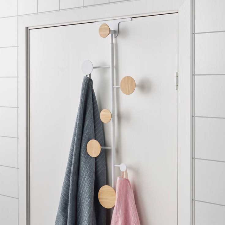 Bärfis, an over-the-door hook rack designed by Gustav—minimalist Scandinavian design with a white metal frame and six round wooden hooks. A functional yet stylish solution for modern interiors, blending practicality with aesthetic appeal.