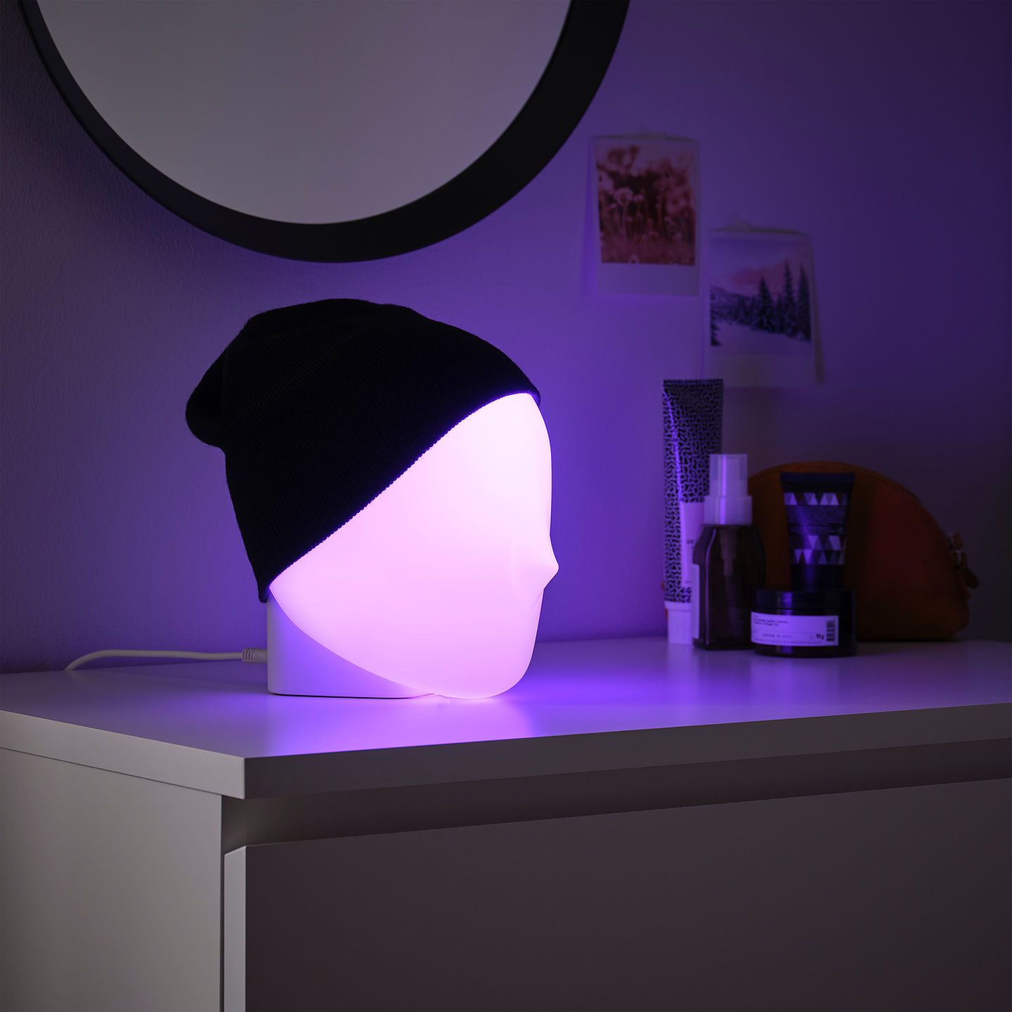 Iskärna mood lamp by Gustav Carlberg, emitting a cool bright white color and features a beanie on top.