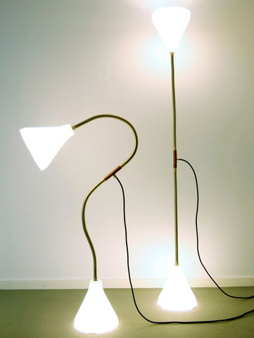 Reflect, a lamp designed by Gustav Carlberg, features a sleek, angular metal form with a reflective surface. Its bold geometric design challenges conventional lighting aesthetics, creating a dynamic interplay of light and shadow.