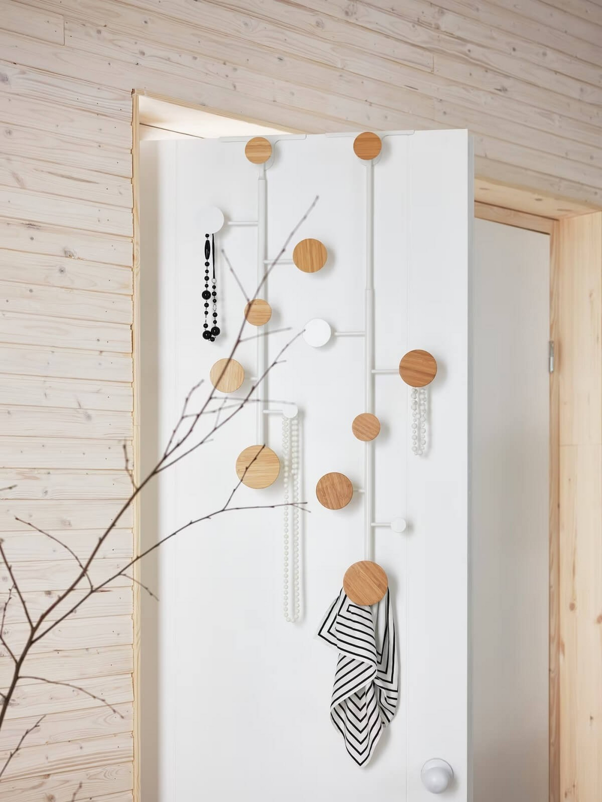 Bärfis—a Scandinavian-inspired wall-mounted coat rack designed by Gustav. Featuring multiple circular wooden hooks in a vertical arrangement, used for hanging accessories, textiles, and decorative elements, merging functionality with modern aesthetics