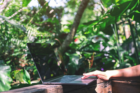 closeup-image-hands-working-touching-laptop-touchpad-wooden-balcony-garden.jpg