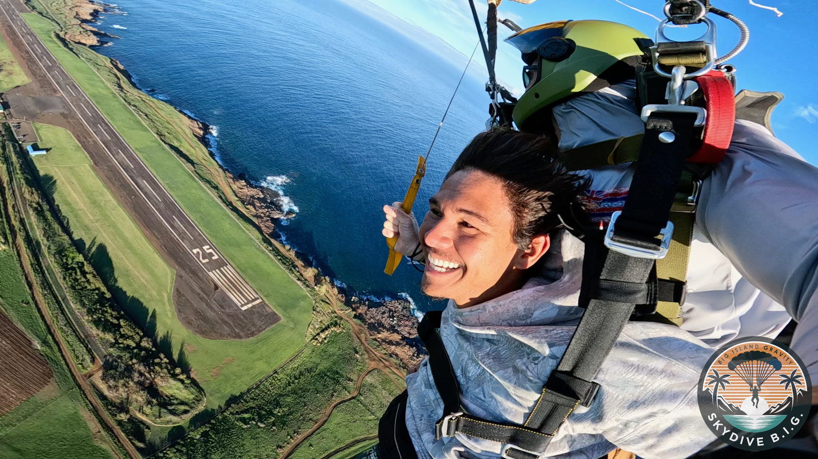 Smiling tandem skydiver in freefall above Upolu Airport