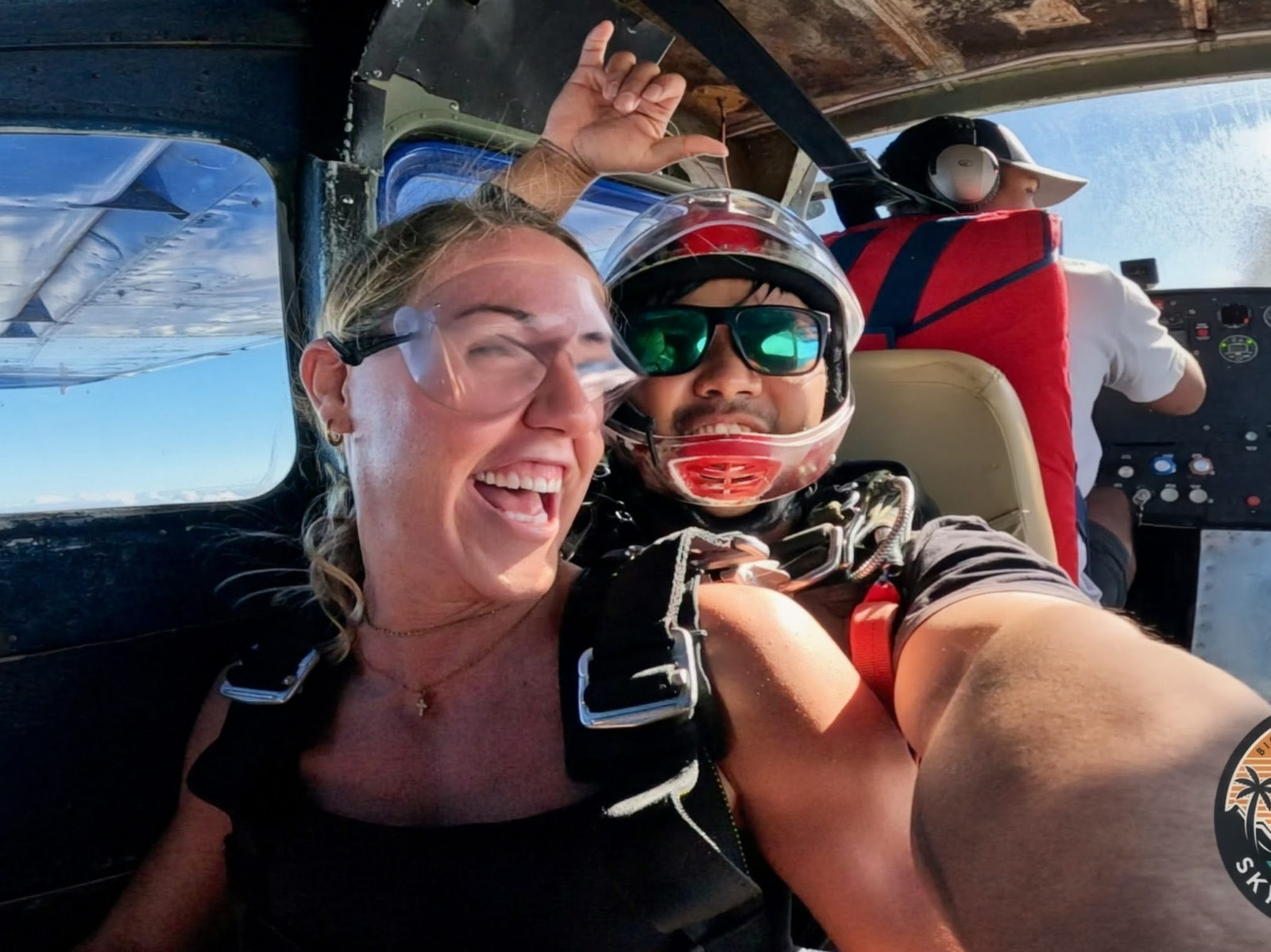 Guest and instructor grinning inside the jump plane
