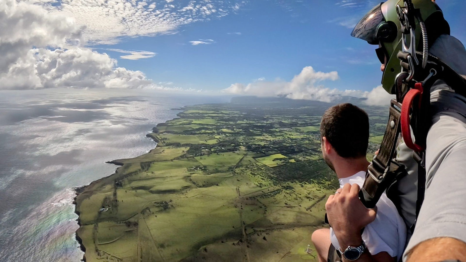 Tandem parachute flying over the Kohala coastline
