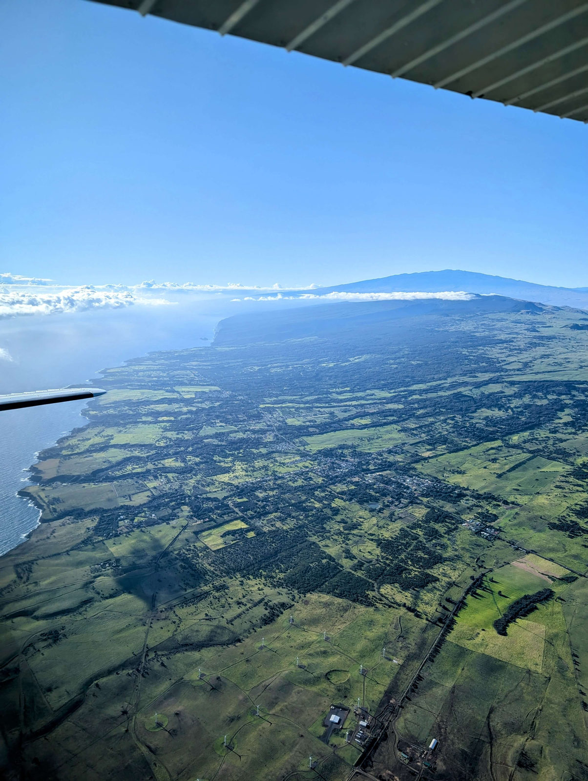 North Kohala coast seen from the jump plane wing on the climb