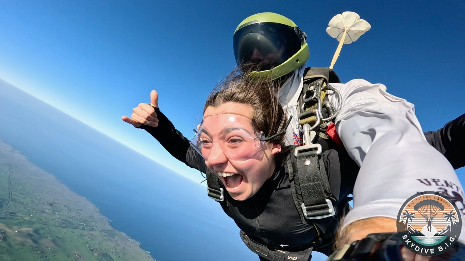 Tandem jumper giving a thumbs up in freefall