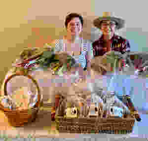 Emilie and Sherry serving fresh produce and baked bread