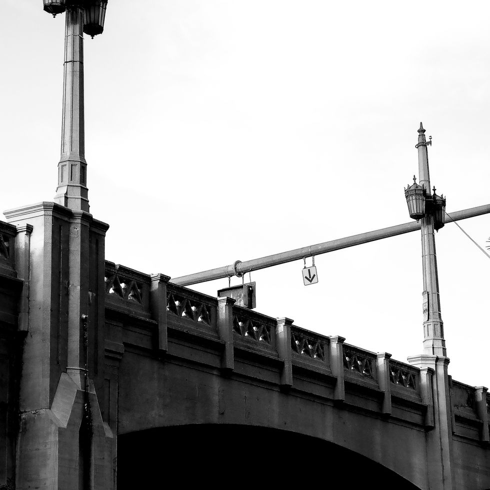 Historic concrete crossing in Los Angeles viewed from below with dramatic negative space. By photographer Alexander Eastick