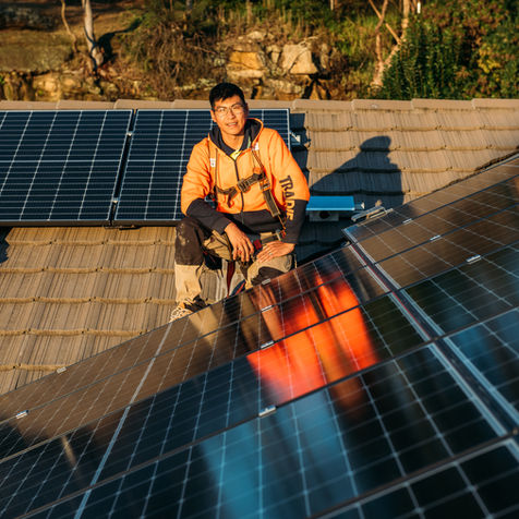 A Person Installing Solar Panels 