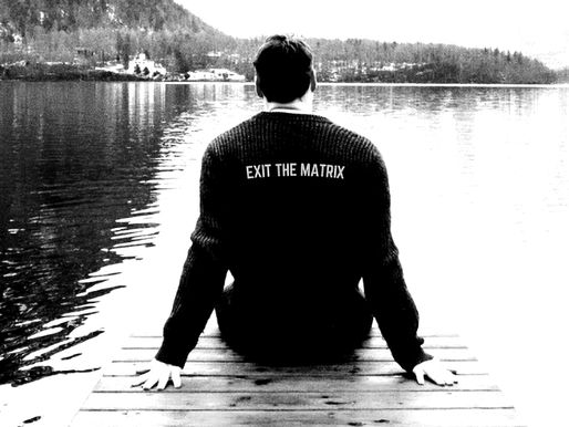 Man overlooking a lake reflecting