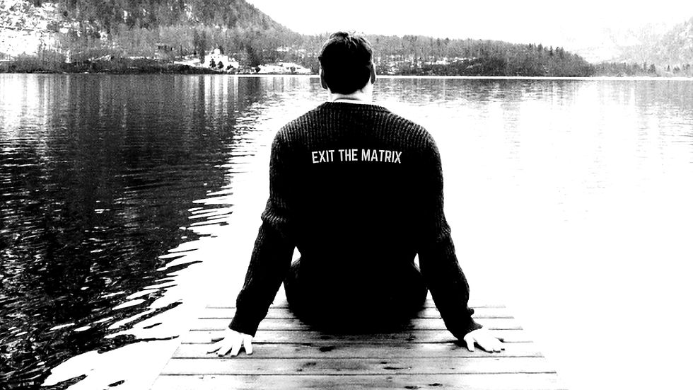Man overlooking a lake reflecting