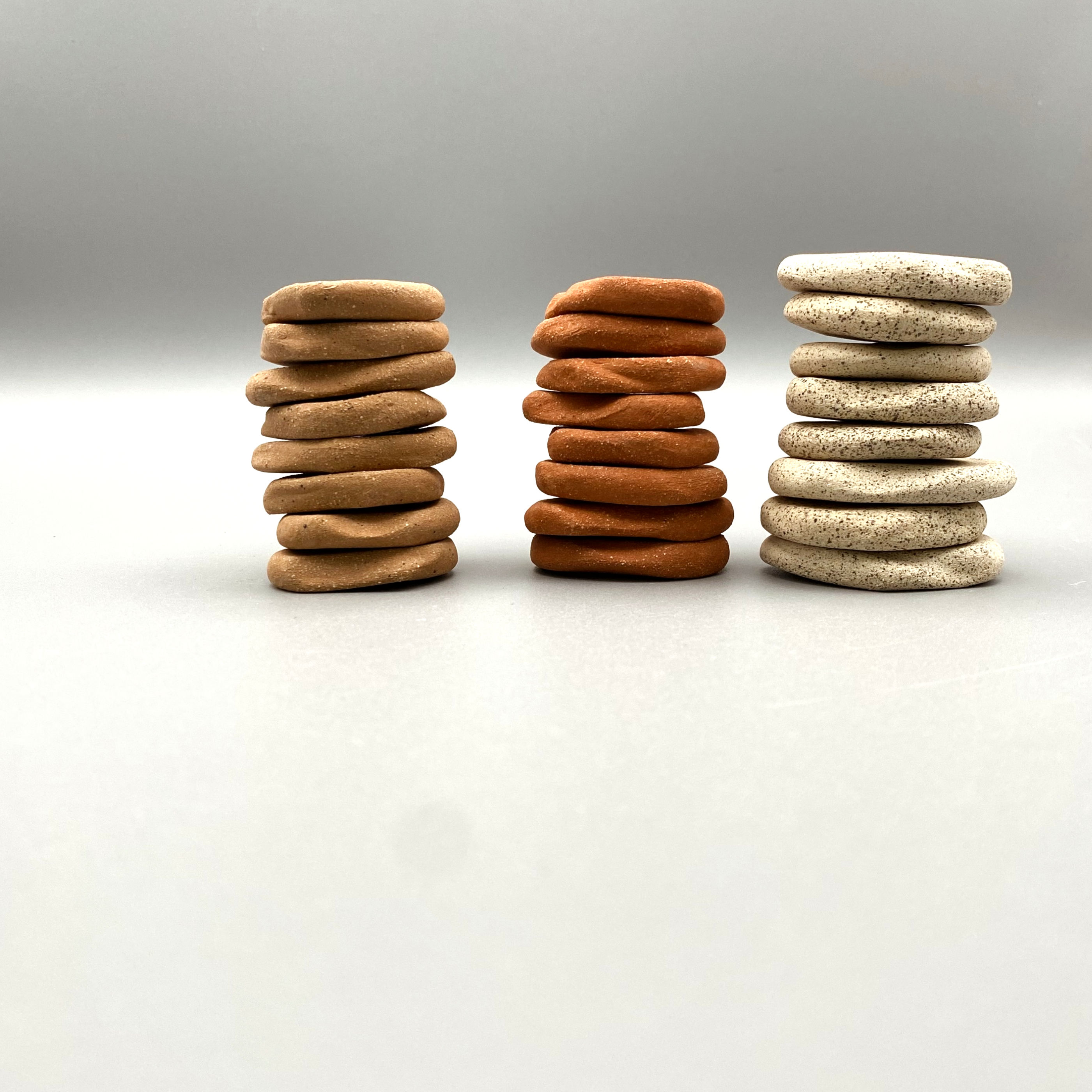 sideview ceramic rune stones stacked in sets of eight by color