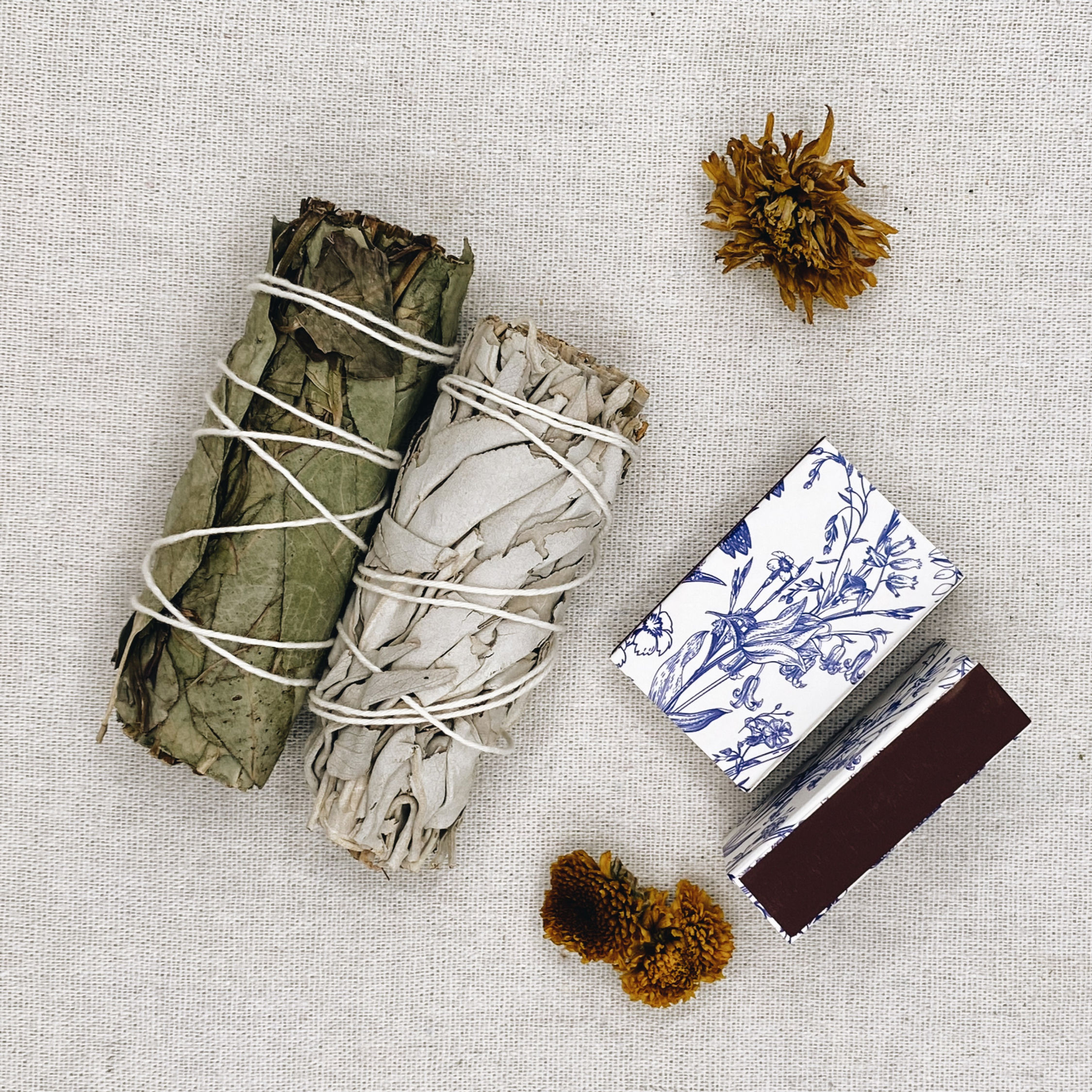 sage bundles and decorative match boxes