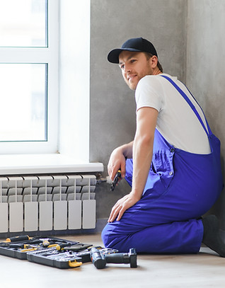 young-man-plumber-checking-radiator-while-installi-2025-03-16-01-49-55-utc.jpg