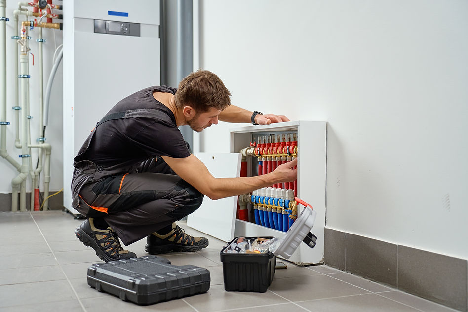 plumber-working-on-pipes-in-building-interior-2026-03-26-23-59-44-utc.jpg
