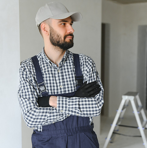 smiling-repairman-standing-near-stepladder-and-loo-2025-03-14-18-08-58-utc.jpg