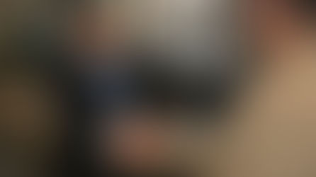 An illustrative image of a security officer greeting a visitor at the main reception desk of a modern London office building