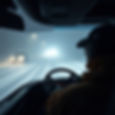 a man driving at night in hazardous conditions